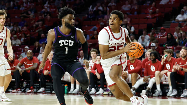 Oklahoma Sooners guard Grant Sherfield dribbles past TCU Horned Frogs guard Mike Miles Jr.